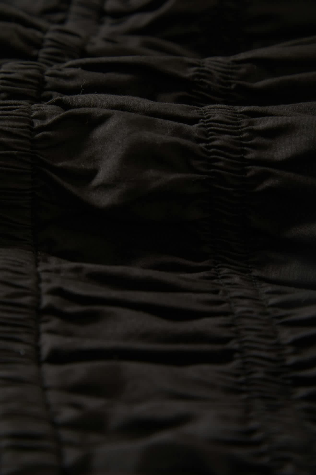 Women's Eden Smocked Jumpsuit in the color Black - Additional Laydown image