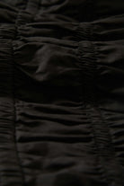 Women's Eden Smocked Jumpsuit in the color Black - Additional Laydown image