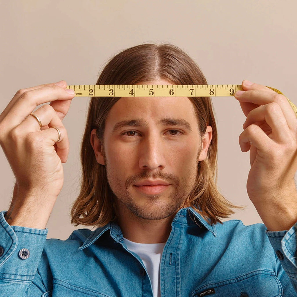 Use a soft tape measure (or string that you can hold up to a standard tape measure) to determine your head’s circumference.