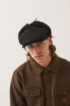 Unisex Barrel Earflap Snap Cap in the color Black/Black - Men's Front View