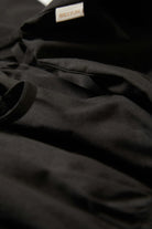 Women's Eden Smocked Jumpsuit in the color Black - Additional Laydown image